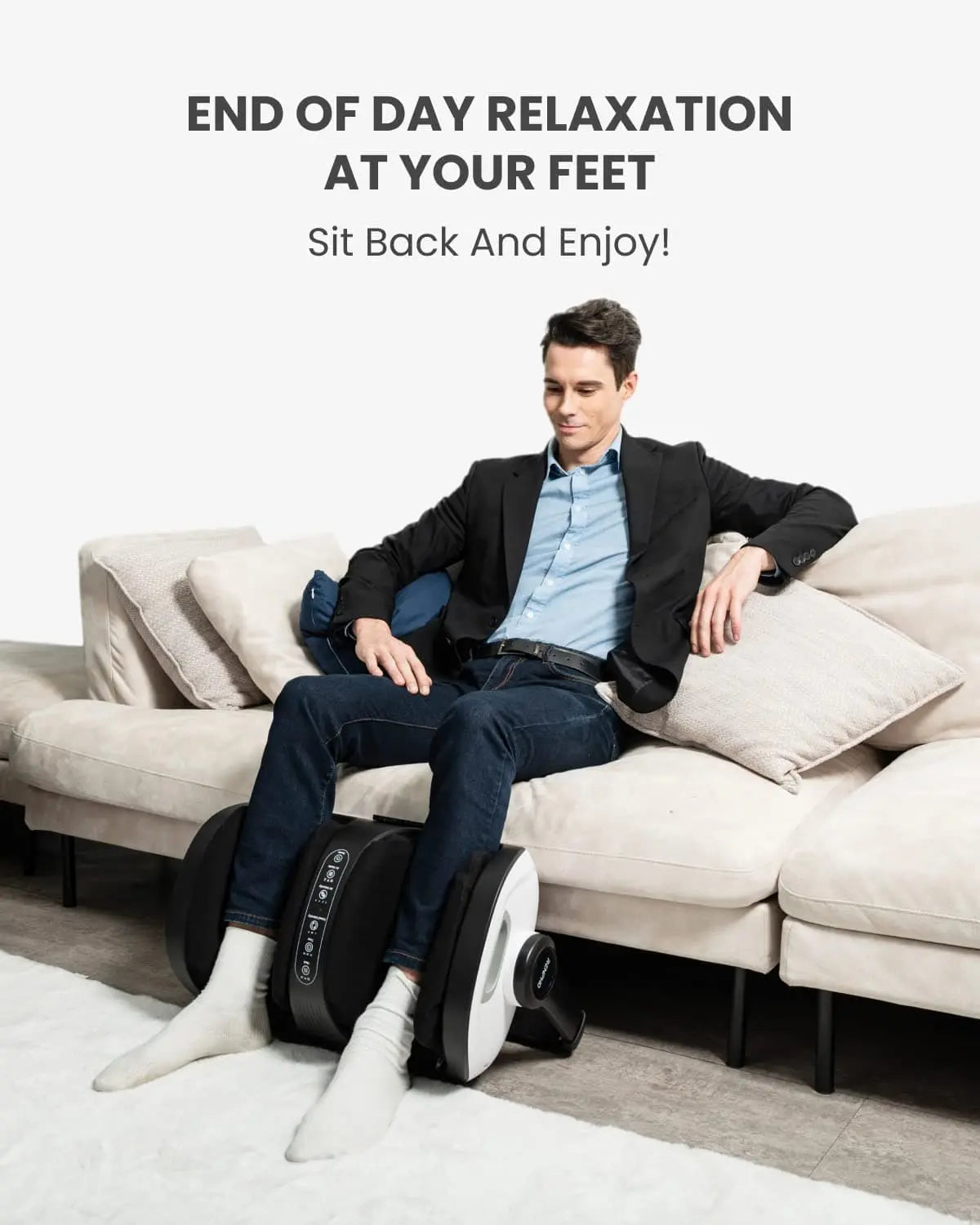 A man in a suit jacket and jeans, sitting on a beige sofa with his eyes closed, is using a Renpho EU Shiatsu Foot and Calf Massager. There are white and beige pillows around him. Text above reads, "End of day relaxation at your feet. Sit back and enjoy!" A coffee table and part of the floor are visible.