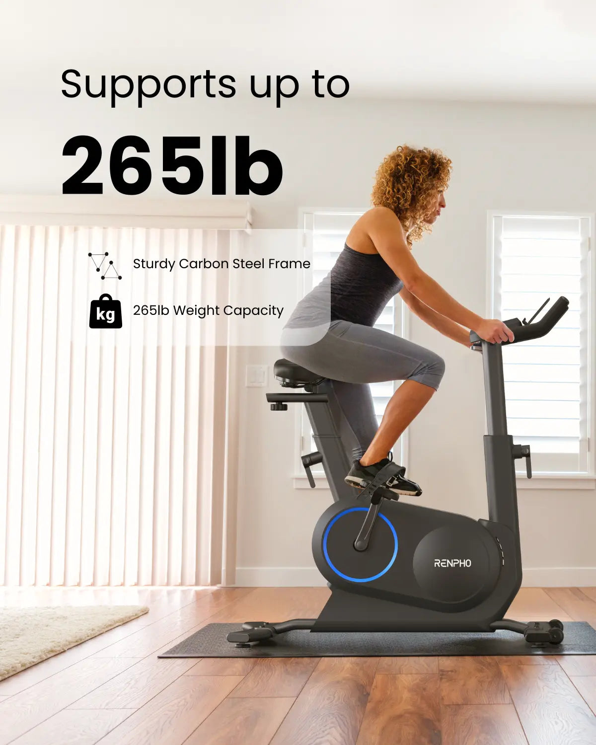 A woman rides a Renpho EU AI Smart Bike S in a bright room with white walls and a window. Overlay text reads "Supports up to 265lb" and includes icons for "Sturdy Carbon Steel Frame" and "265lb Weight Capacity." The black bike, with blue accents, offers an immersive fitness experience with diverse training programs.