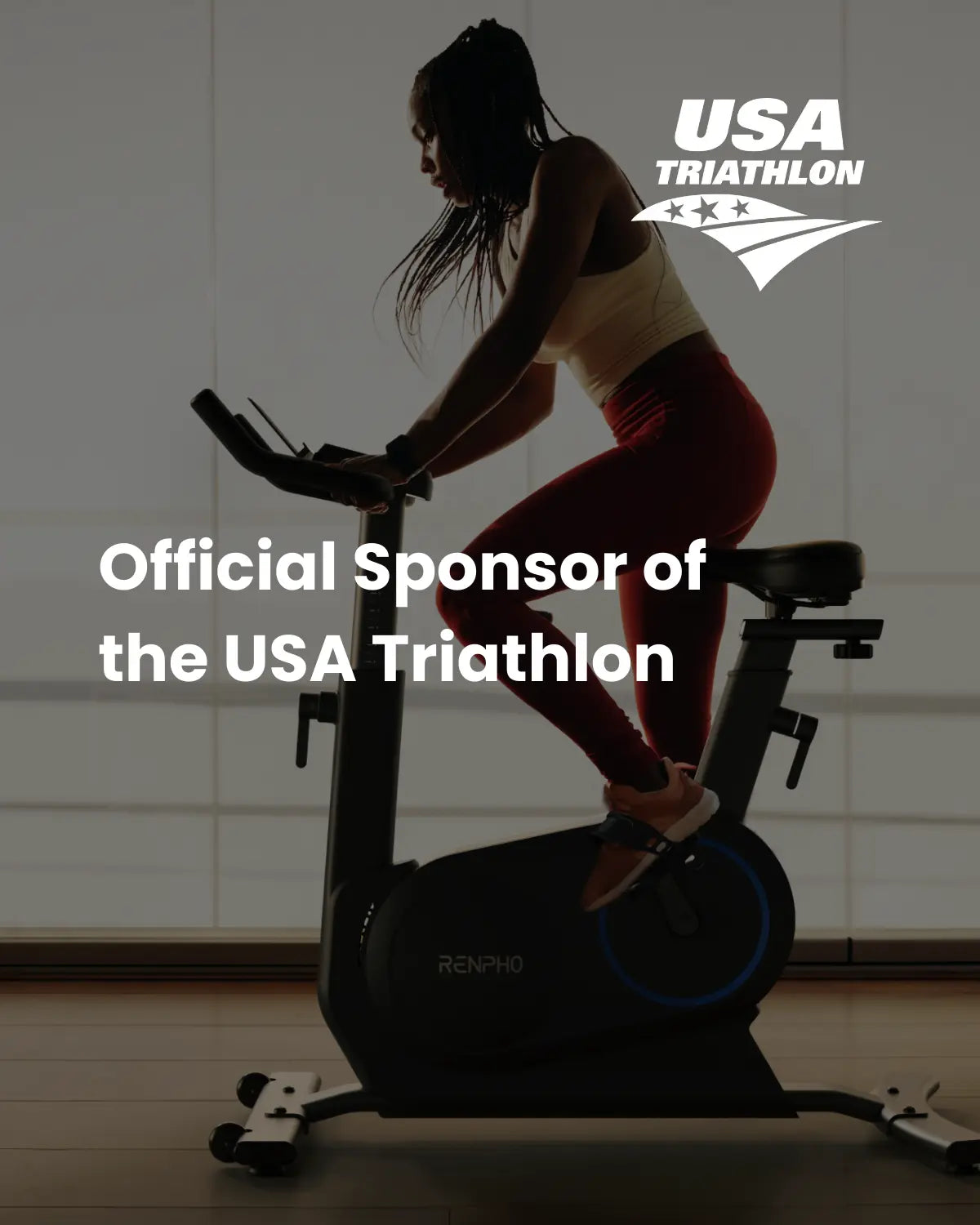 A person rides a Renpho EU AI Smart Bike S indoors with the text "Official Sponsor of the USA Triathlon" overlaid. The silhouette shows the person in cycling attire against a large window, immersed in an immersive fitness experience. The logo of USA Triathlon featuring a star and stripes design is at the top right.