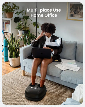 A person sits on a gray sofa in a home office, working on a laptop with papers scattered beside them. One hand supports their head while their feet rest on the Renpho EU Shiatsu Foot Massager Machine [2nd Generation], soothing their sore feet. The background features plants and shelves, and text at the top reads, "Multi-place Use Home Office.