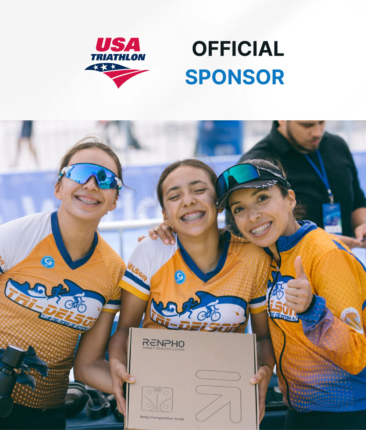 Three female cyclists, wearing USA Triathlon jerseys and sunglasses, smiling and embracing each other at a fitness event. One holds a cardboard box with the Elis Solar Smart Body Scale sponsor logo. "Official Sponsor" text and USA Tri